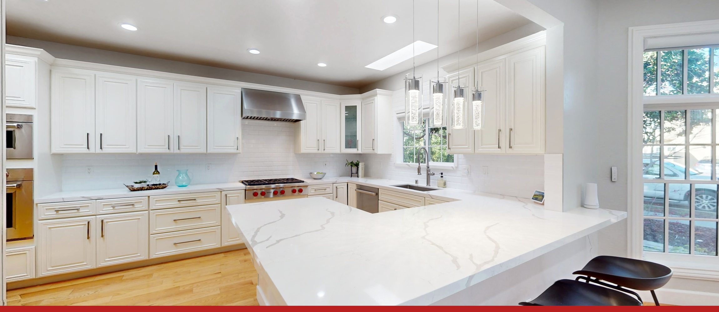A Palo Alto kitchen in daylight, with a marble peninsula and a window over the sink