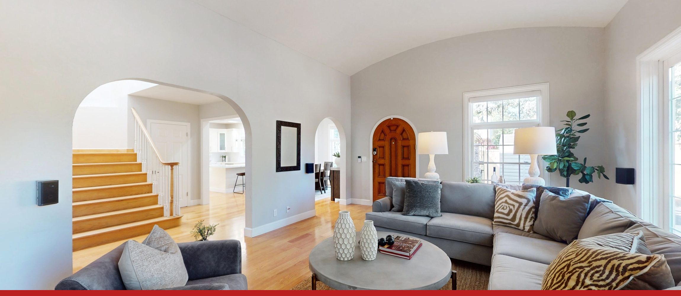 A Palo Alto living room: three arched openings, a stair, and a barrel-vaulted ceiling