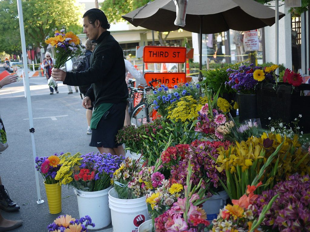 Buckets of cut flowers at a market stall at Third and Main Street