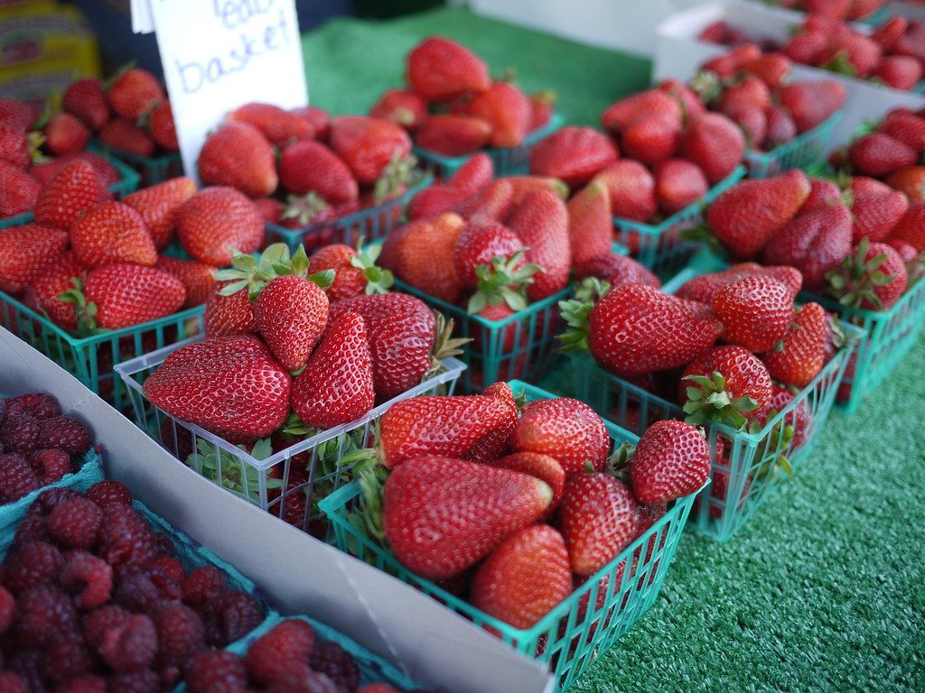 Baskets of strawberries at a farmers’ market stall
