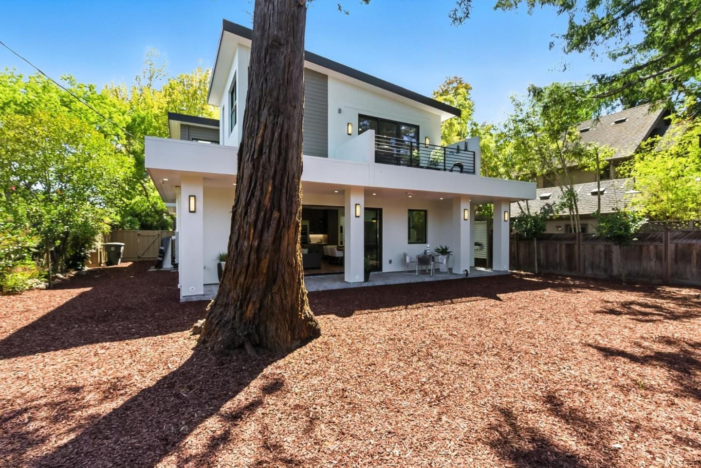 2200 Saint Francis Drive before preparation — the rear garden as bare mulch under the redwood, with the house behind it