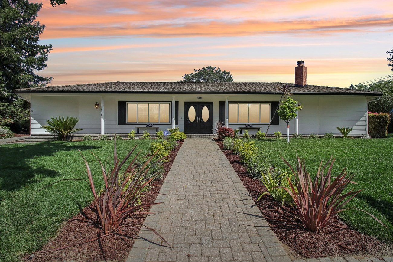 13056 Brandywine Drive at twilight — the front elevation beyond a paver walk and new planting