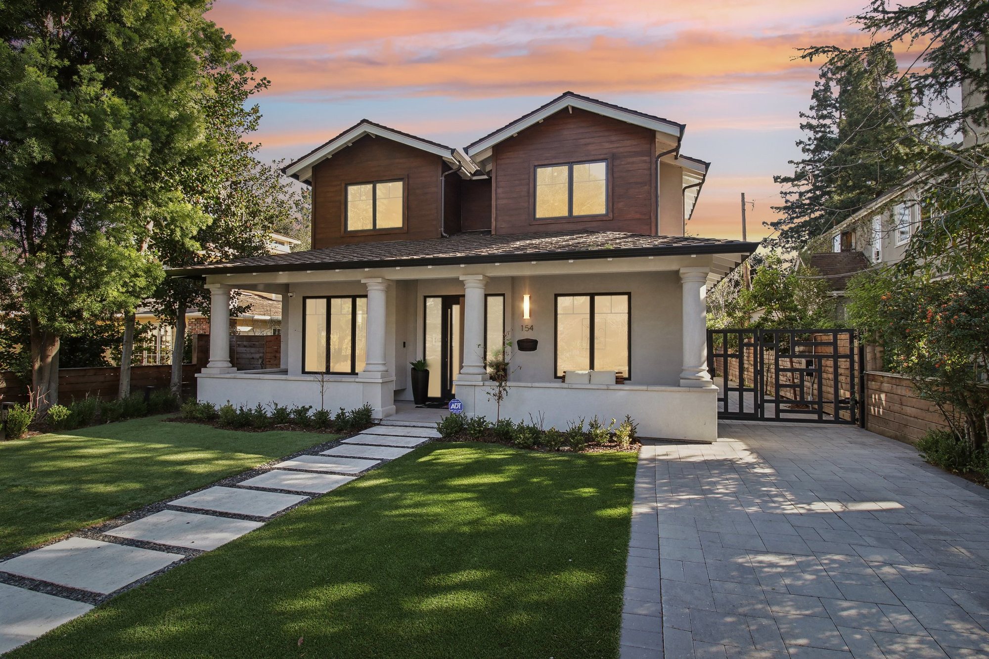 154 Coleridge Avenue at dusk — the shingled front elevation lit from within