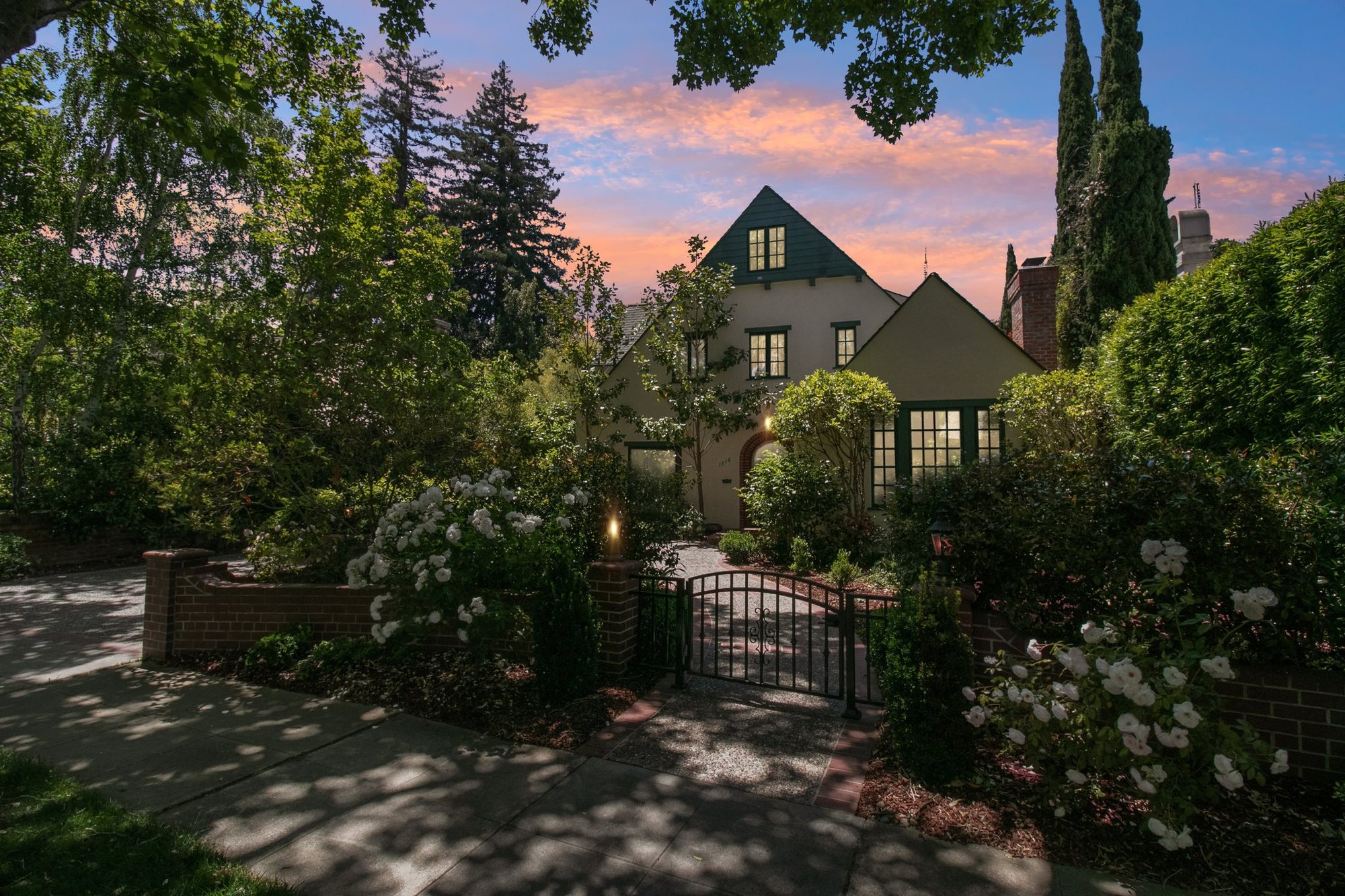 1716 Fulton Street at dusk — the 1930s front elevation behind its garden gate