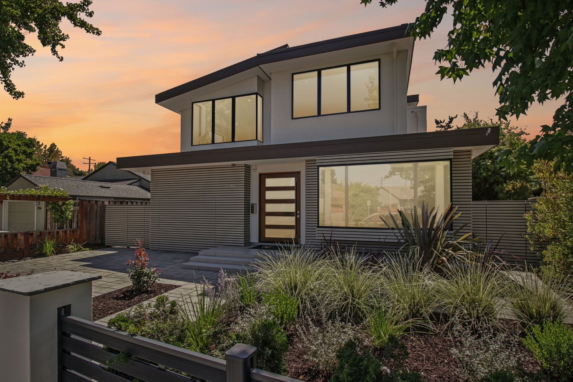 2280 Saint Francis Drive at dusk — the front elevation, entry court and new planting