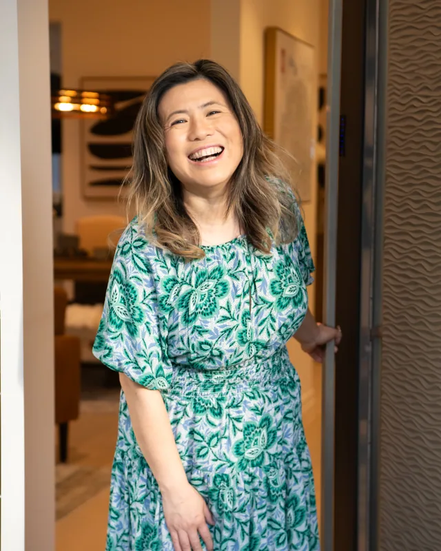 Maggie laughing in the doorway of one of her listings