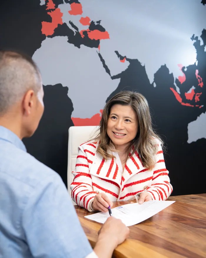 A listing agreement being signed across the table at the Keller Williams Palo Alto office